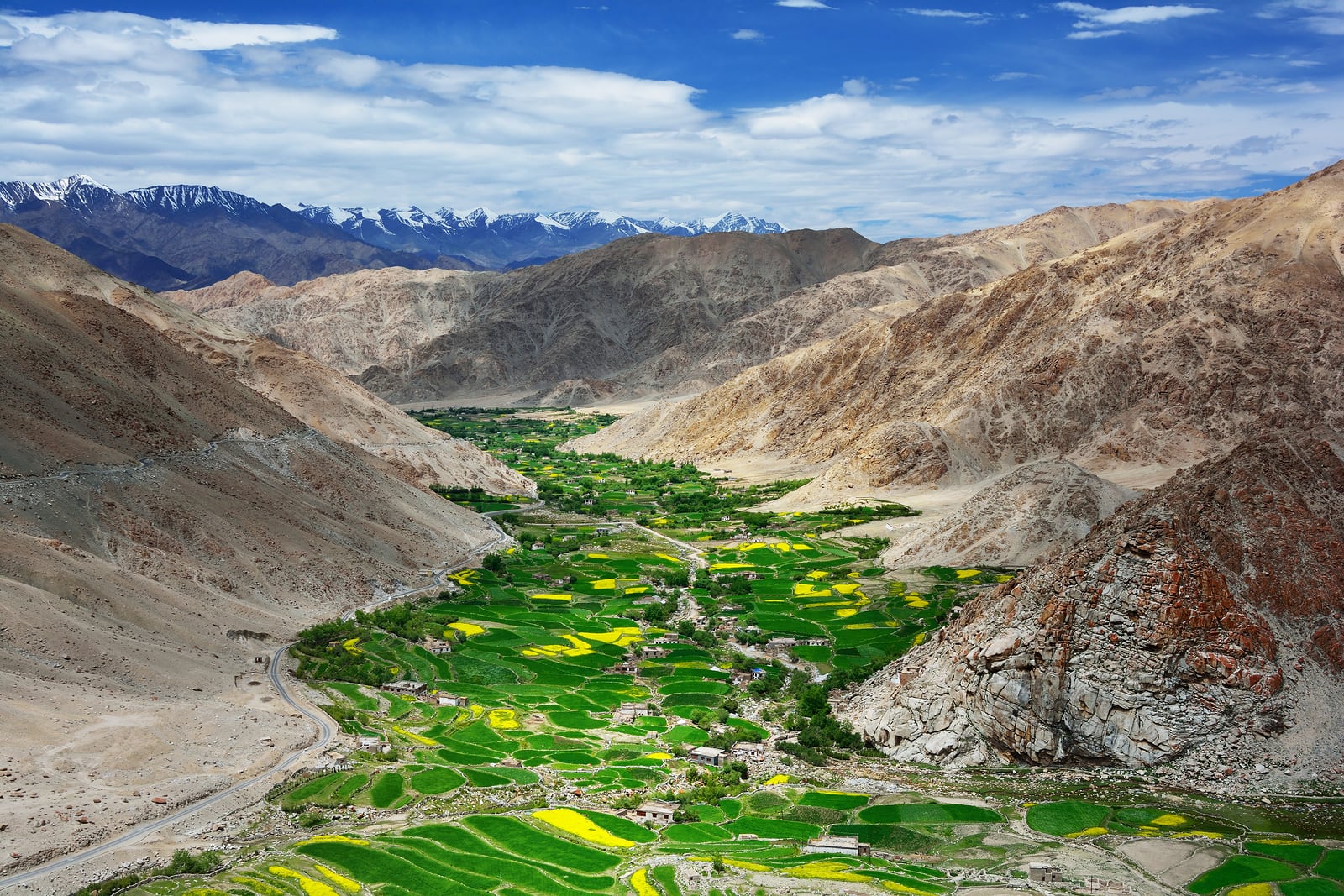 High-mountains-and-green-valley-with-farmland-in-Tibet